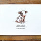 A personalized baby shower favor card featuring a watercolor illustration of a spotted calf named 'AIMEE' with the date '06.08.