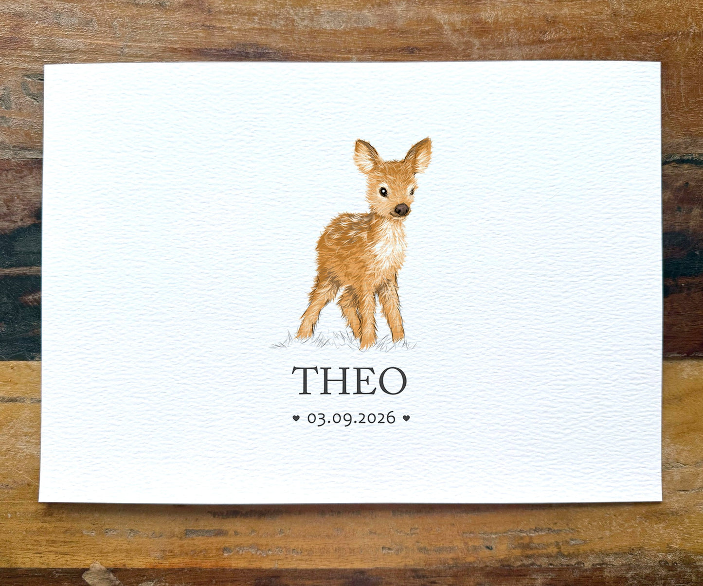 A personalized watercolor art print featuring a young brown spotted deer standing on a white textured background, with the name 'THEO' and the date '03.09.