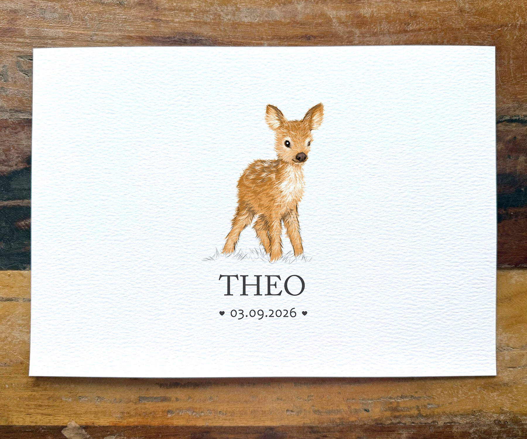 A personalized watercolor art print featuring a young brown spotted deer standing on a white textured background, with the name 'THEO' and the date '03.09.