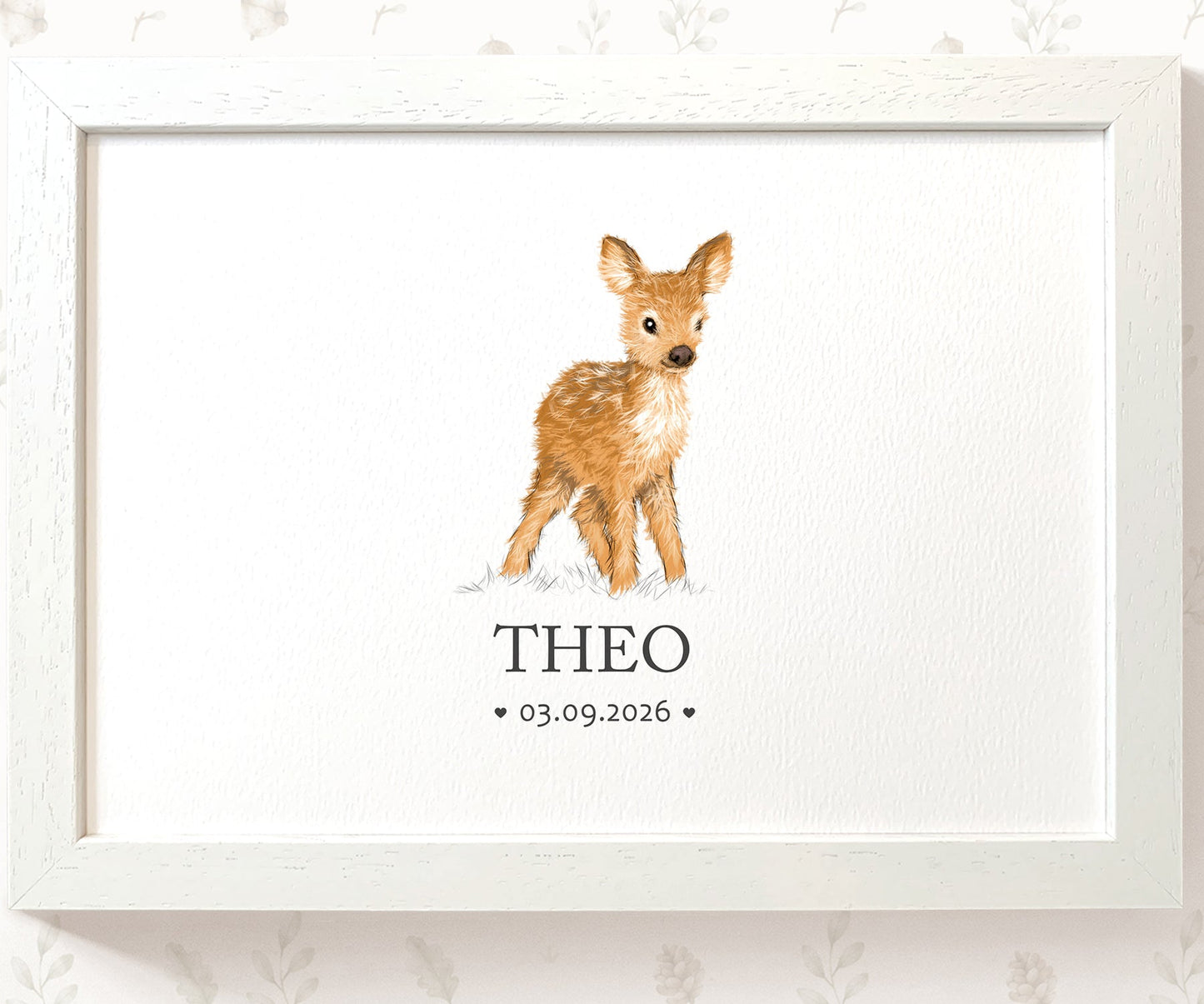 A framed personalized art print featuring a watercolor illustration of a young brown deer standing on white paper, with the name 'THEO' and the date '03.09.