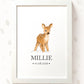 A framed personalized baby print featuring a watercolor illustration of a fawn with the name 'MILLIE' and the date '01.08.