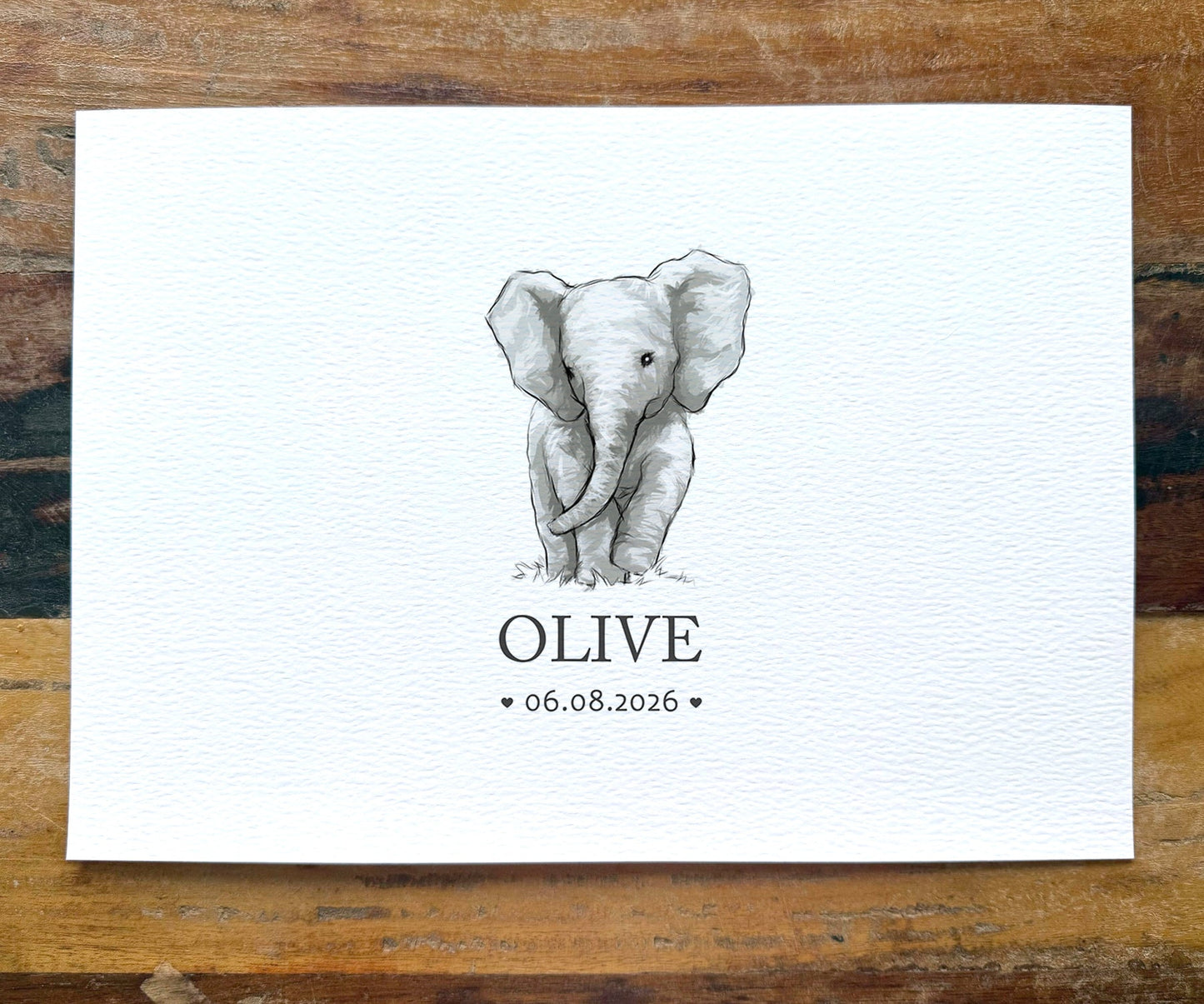 A personalized baby shower card featuring a hand-drawn gray elephant illustration and the name 'OLIVE' with the date '06.08.