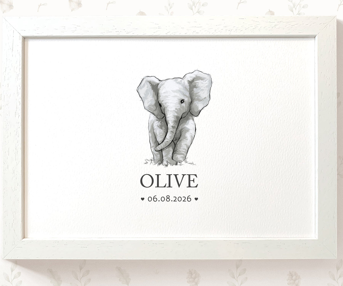A framed personalized elephant print featuring a black and white sketch of a baby elephant with the name 'OLIVE' and date '06.08.