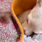 Close-up of pink floral cotton fabric and fleece lining on handmade dog blanket