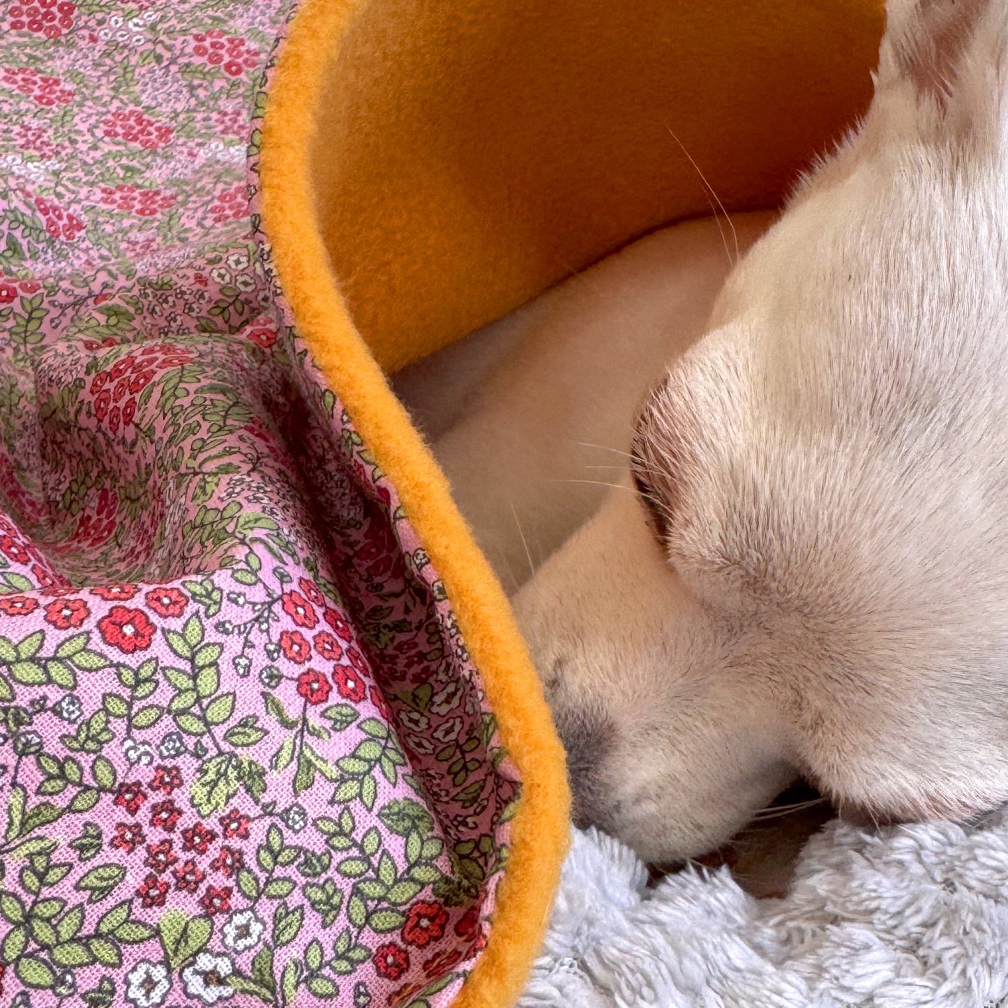 Close-up of pink floral cotton fabric and fleece lining on handmade dog blanket