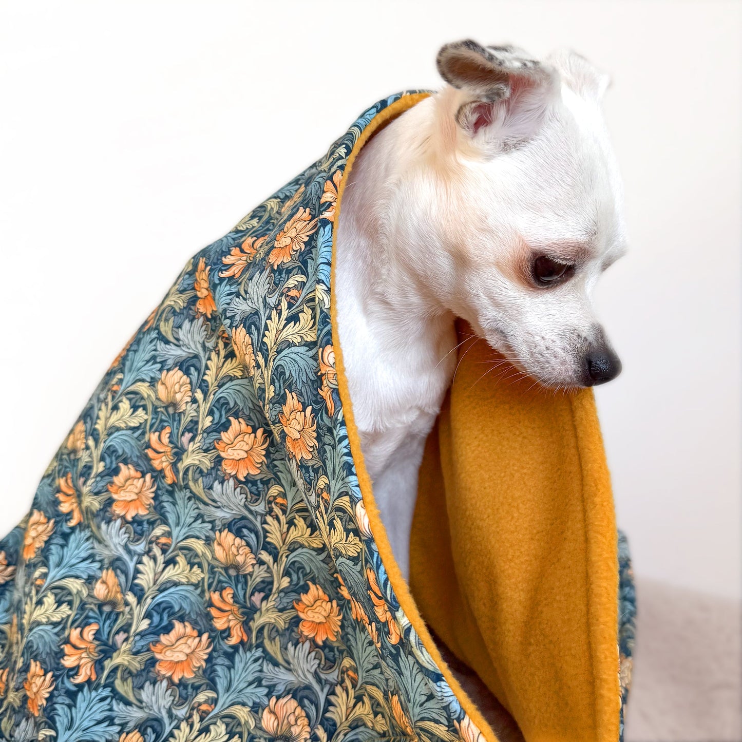 Handmade dog blanket with patterned cotton top and ochre fleece lining for small, medium and large dogs