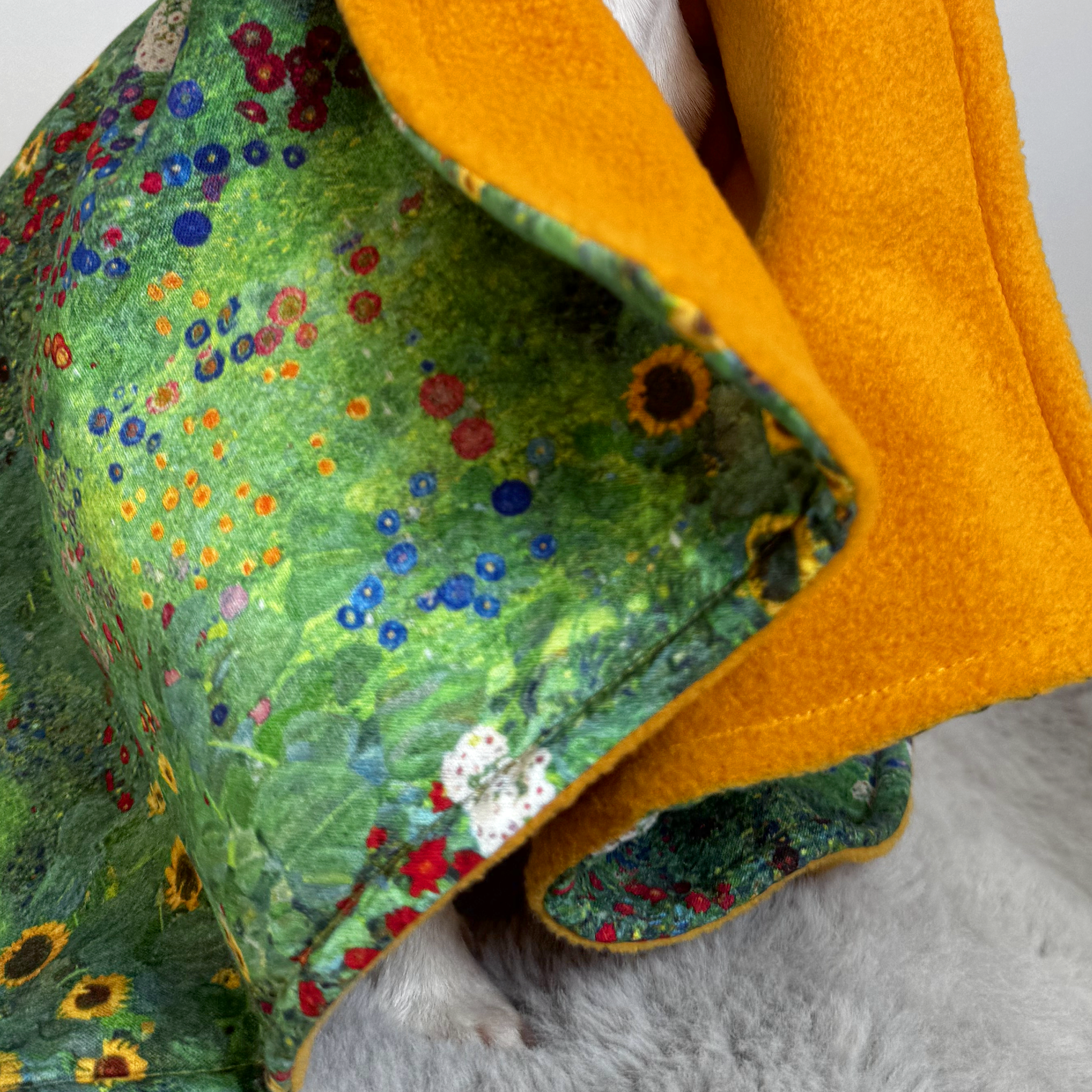 Close-up of floral cotton fabric and fleece edge on handmade dog blanket