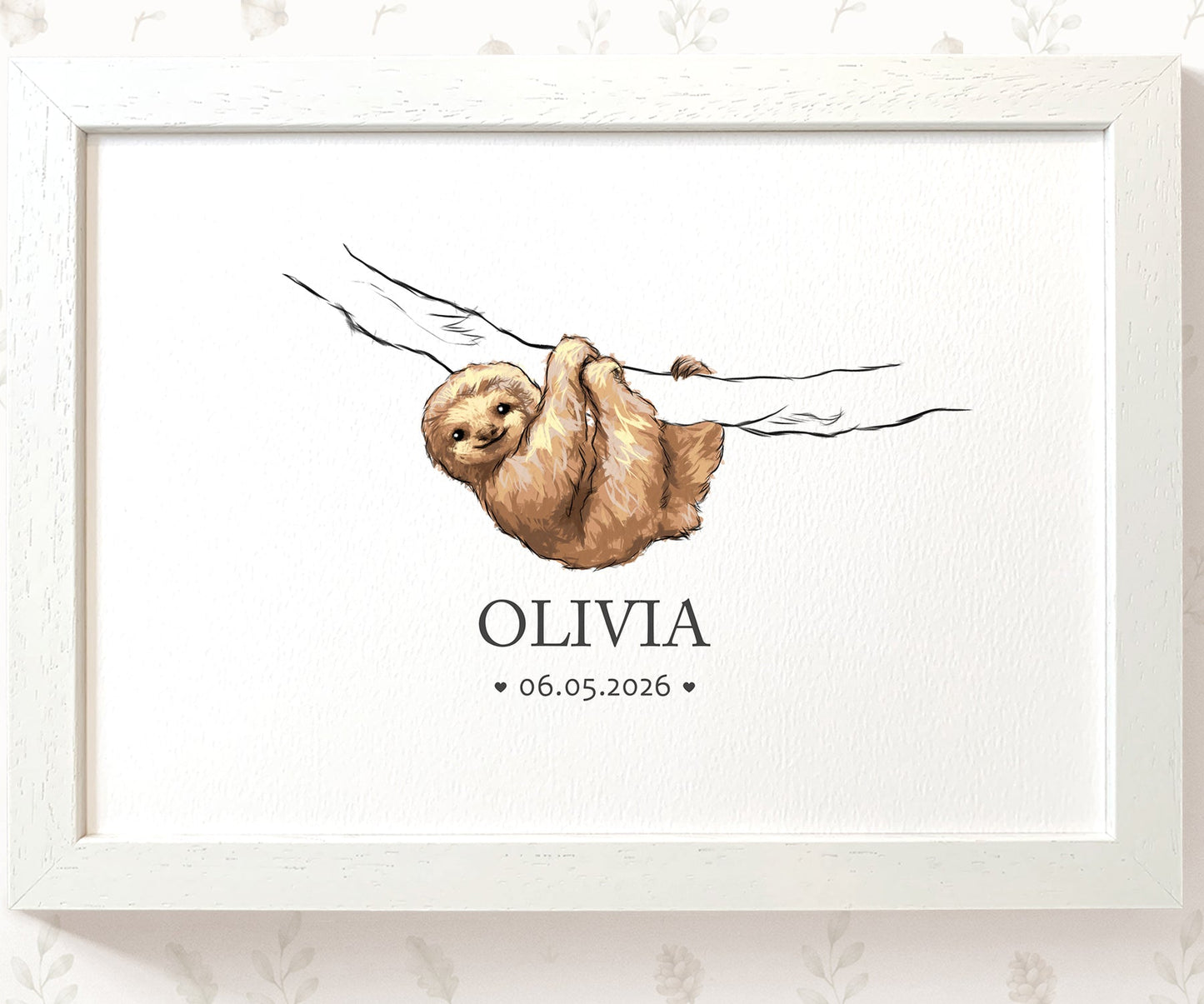 A framed personalized art print featuring a watercolor illustration of a brown sloth hanging from a branch, with the name 'OLIVIA' and the date '06.05.