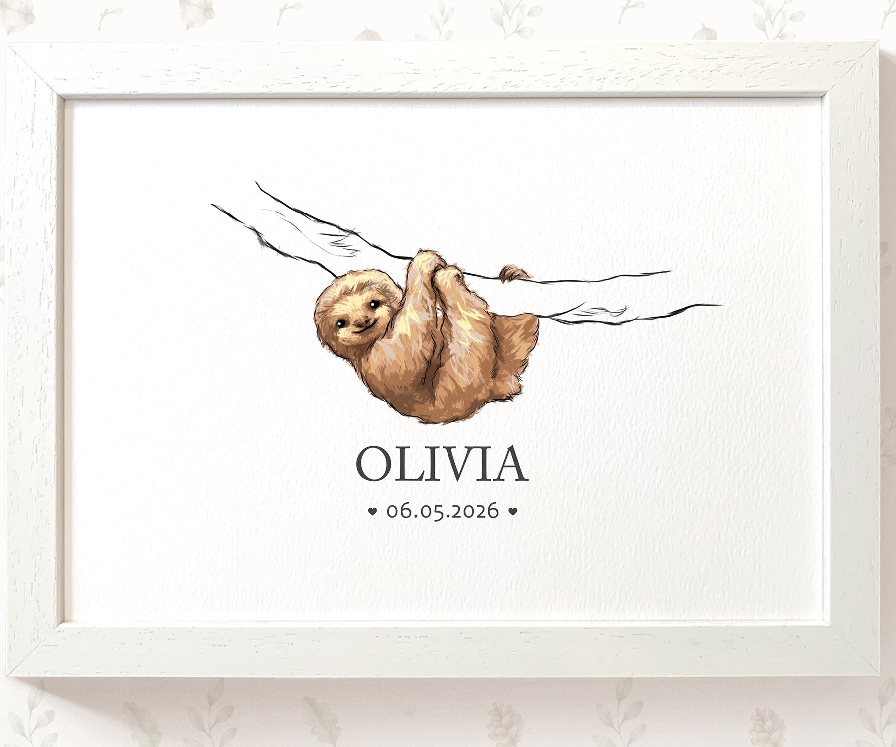 A framed personalized art print featuring a watercolor illustration of a brown sloth hanging from a branch, with the name 'OLIVIA' and the date '06.05.