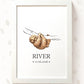 A framed personalized art print featuring a watercolor illustration of a sloth hanging from a branch, with the name 'RIVER' and the date '12.06.