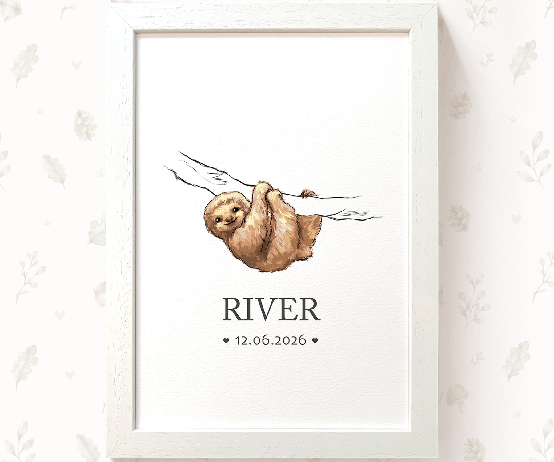 A framed personalized art print featuring a watercolor illustration of a sloth hanging from a branch, with the name 'RIVER' and the date '12.06.
