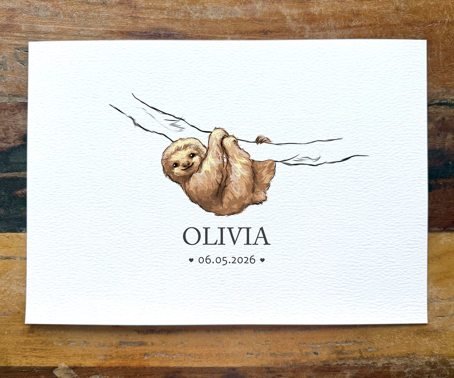 A personalized watercolor art print featuring a brown sloth hanging from a branch, with the name 'OLIVIA' and the date '06.05.