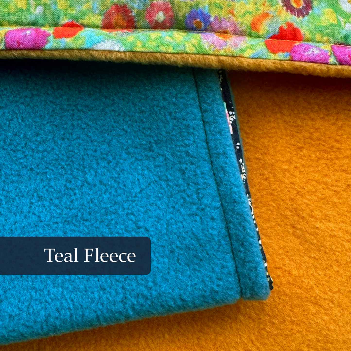 Teal fleece underside of handmade dog blanket showing soft and cosy lining